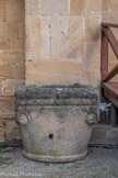 <center>Château-Abbaye de Cassan</center>Devant l'entrée de l’église, on peut voir des fonts baptismaux monolithiques en grés ouvragé, d'époque romane. La cuve, ressemblant à un chapiteau monumental, est ornée dans ses angles de volutes symbolisant une tête de bélier. Elle se trouvait à l’intérieur de l’église et était vraisemblablement équipée d’un couvercle.