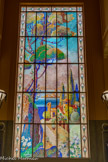 <center>Immeuble Gloria Mansions</center>D'une technique inédite, une mosaïque de morceaux de verre colorés collés entre deux vitres, les vitraux, signés par Lasalle d'après des cartons du peintre Mahokian, présentent des paysages pointillistes de Signac ou Seurat. Ce tableau représente un paysage de Théoule à l'entrée de l'Estérel.