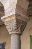 <center>Le cloître de Saint-Genis des Fontaines.</center>Les serpents : Chapiteau noir représentant, à deux angles opposés, des visages habités de serpents ondulants. Significations possibles : les tourments de l’enfer, ou bien une image macabre de la corruption des corps. La lettre « B » couchée pourrait être la marque du sculpteur.