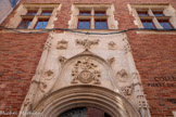 <center>Hôtel de Bernuy</center>À l'intérieur de l'accolade, au-dessus de la porte, le médaillon central figure une tête d'Apollon, inscrit dans un soleil rayonnant. Il a remplacé, dans la deuxième moitié du XIXe siècle, le monogramme du Christ que les Jésuites avaient substitué au blason de la famille de Bernuy au XVIIe siècle. Le médaillon est entouré d'une couronne de fleurs tenue par deux putti porteurs de lances. Au-dessus, un troisième putto tient un phylactère où se lit la devise de Jean de Bernuy : Si Deus pro nobis (« Si Dieu est avec nous [, qui sera contre nous ?] » en latin). À l'extérieur de l'accolade sont disposés quatre médaillons ornés de bustes de personnages