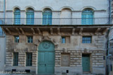 <center>Temple protestant d'Arles</center>Façade arrière.
En 1847, les protestants obtiennent une subvention du ministère des cultes, et grâce à des donateurs une école protestante de garçons et une de fille furent ouvertes. Les ateliers du chemin de fer avaient besoin de beaucoup d’ouvriers qui venaient de la Grand Combe, d’Alès, du pays cévenol, et beaucoup étaient protestants. Il a fallu trouver un lieu de réunion suffisamment grand. Ce bâtiment était en vente pour 40000 francs, une dame anglaise a prêté 25000 francs et le reste a été obtenu par une souscription. Comme l’église réformée n’était pas reconnue officiellement, quelqu’un a servi de prête nom : il a acheté le bâtiment et l’a loué aux protestants. Les écoles seront hébergées dans les étages supérieurs. 
En 1862, un premier pasteur auxiliaire est nommé, et en 1867, Polydore Vesson est le premier pasteur officiel, malgré l’opposition du maire de l’époque, le Baron Laugier de Champouze, ainsi que celle de la population. La municipalité a obligé les protestants à rentrer par la petite rue de derrière et à murer les grandes portes qui donnent sur l’esplanade. Un siècle après, en 1966, elles furent rouvertes.