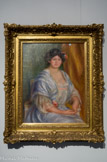 <center>Portrait de Mme Thurneyssen</center>PIERRE-AUGUSTE RENOIR (1841-1919). Huile sur toile, 1908. 
C'est en 1908 que Renoir fait la connaissance des Thurneyssen. Cette toile est la première d'une longue série de portraits de cette famille que des liens d'amitié croissants unissent au peintre. Monsieur Thurneyssen était un intellectuel de Munich, qui avait hérité d'une entreprise familiale de chimie. Bon client d'Ambroise Vollard et d'autres marchands, il devint en quelques années un des plus grands collectionneurs de Renoir.
Le Portait de Madame Thurneyssen reste fidèle à la peinture de Renoir en poursuivant son hommage à la féminité et à la maternité qui traverse toute son œuvre. Le sujet aux formes généreuses expose sa gorge au spectateur et est vêtu d'une robe diaphane ; la carnation de sa peau rosie ressort en contrepoint sur le bleu froid de la robe. La retenue est bien là, dans le croisement des doigts et l'attitude sage du modèle. Cet équilibre, ou cette tension, se retrouve dans la palette de couleurs de l'arrière-plan, entre jaune-orange fiévreux et vert d'eau, en passant par le triangle de bleu ciel que forme la robe au centre.