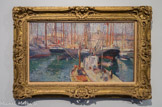 <center>Le port de Marseille</center>HENRI MARTIN, (1860-1943). Huile sur toile.
Si Henri Martin à n'en pas douter fut avant tout, selon l'expression de Claude Juskiewenski, un « peintre languedocien » terrien dans l'âme, il fut aussi très séduit, comme les impressionnistes et ses contemporains néo-impressionnistes, par la mer, les étangs et les ports qui permettaient, à partir des reflets sur l'eau, de valoriser les nombreuses variations techniques du divisionnisme. C’est ainsi que le port de Marseille fut un sujet aimé. Il le choisit pour les décors monumentaux de la Caisse d'épargne de Marseille (inaugurée en 1904) et pour Conseil d'État ( Travail de Ia mer, Salon de 1922).
Cette huile sur toile est sans doute une des nombreuses esquisses et études sur le motif réalisée pour la Caisse d'épargne ( commandée par Rostand, père d'Edmond), dont certaines furent exposées chez Georges Petit en 1910. Henri Martin propose ici une vue légèrement plongeante du port et de la forêt de mâtures à travers laquelle on aperçoit les maisons du quai qui nous fait face. Il impose une horizontalité qu'il affirme délibérément La composition, qui semble improvisée et aléatoire, est en fait très structurée autour d'un schéma sous-jacent très orthogonal.