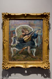 <center>La petite mandoliniste (Marthe Le basque)</center>HENRI LEBASQUE (1865-1937). Huile sur toile, 1904
Lebasque est le peintre de la vie heureuse et de l'intimité. Ses modèles favoris sont sa famille, le plus souvent sa femme et ses filles : Hélène - dite Nono - et Marthe. Ici nous voyons cette dernière assise dans un fauteuil à la reine Louis XV recouvert d'une tapisserie verte. La jeune enfant porte une robe bleue à collerette qui découvre ses jambes. Ses chaussures montantes marron sont de la même teinte que ses longs cheveux bruns retenus par un nœud rouge. Marthe est absorbée dans la contemplation de la mandoline dont elle joue, son visage penché vers les cordes de son instrument. La tranquille scène d'intérieur se passe sans doute dans l'atelier du peintre, puisque des toiles stockées à l'arrière-plan montrent des paysages. Lebasque peint ici une scène familière de la vie quotidienne où la jeune musicienne Marthe semble pourtant être prise sur le vif.