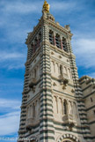 <center>Notre-Dame de la Garde</center>Le clocher avec la Vierge. La reconstruction du clocher en 1843 lui permet de recevoir non plus une cloche mais un bourdon commandé à un fondeur lyonnais Gédéon Morel et acheté grâce à une souscription. Le bourdon fondu le 11 février 1845, arrive à Marseille le 19 septembre 1845. Le bourdon est mis en place le mercredi 15 octobre. La consécration du sanctuaire est donnée le samedi 4 juin 1864 par le cardinal Villecourt.