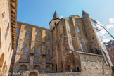 <center>L'église abbatiale Sainte-Foy</center>Façade sud. L'abbatiale est construite avec un assemblage de grès rouge et de calcaire jaune. 
Le transept sud est agrémenté d'une tourelle cylindrique.