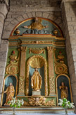 <center>Nasbinals. Église Sainte-Marie. </center>Le retable de la vierge (XVIIe siècle), en bois doré et peint, ferme l’absidiole Sud. Construit sur ordonnance corinthienne à pilastres et volutes à feuillages. Il ménage trois niches.
Au centre, une vierge ouvre les bras dans un geste d'accueil. Les deux autres personnages sont de facture différente.