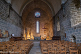 <center>Aubrac. L’église Notre-Dame des Pauvres.</center>On retrouve, dans ce bâtiment, des traces importantes de ce que fut l’ancien hospice d’accueil (1198), transformé en église entre 1332 et 1356. Au fond de la nef, une fontaine devait servir au symbolique lavage des pieds des pèlerins. L’architecture romane, très dépouillée, est en totale harmonie avec la sobriété des lieux. C’est le seul ouvrage hospitalier du XIIe siècle qui nous soit parvenu dans un tel état de conservation. On doit cette solidité à l’utilisation d’un tuf volcanique léger pour cette partie de l’ouvrage. En dehors du mur nord, aveugle pour des raisons climatiques, de modestes fenêtres ont été agencées au sein des trois autres façades, en vue d’assurer un éclairage continu. Les arcs doubleaux à simple rouleau retombent sur des consoles en forme de colonnettes.