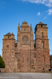 <center>La cathédrale Notre-Dame de Rodez</center>Bien que les travaux de construction aient duré de 1277 jusqu’à la fin du XVIe siècle, la cathédrale bénéficie d’une remarquable unité tant à l’intérieur qu’à l’extérieur. En effet, le parti général de l’édifice fut fixé dès l’origine. Ce type de plan est attribué à l’architecte Jean Deschamps, qui a mis en pratique dans le Midi les principes de l’architecture gothique définis dans la France du Nord. L'aspect sévère de la façade occidentale témoigne de sa vocation défensive : elle est flanquée de deux tours massives qui étaient incorporées aux remparts. Seule « anomalie » à la rigueur flamboyante de l’ensemble : un frontispice placé au faîte de la façade au milieu du XVIe siècle.