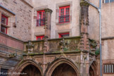 <center>La maison de Benoit</center>Les murs rouges de la bâtisse contrastent avec ceux de la placette. Ici, les gargouilles sont à portée de main