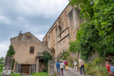 <center>Najac</center>L’église Saint Jean l'Evangéliste. Côté sud, le mur de l’église est soutenu par de puissants contreforts entre lesquels viennent se positionner de longues fenêtres en tiers-point.