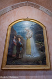 <center>Bozouls</center>Église Sainte-Fauste. Tableau : Apparition de Notre-Dame de la Salette aux deux petits bergers Mélanie Salvat et Maximin Giraud. Tableau réalisé par Joseph Castanié, peintre aveyronnais (1819-1884).