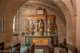 <center>Estaing</center>L'église Saint-Fleuret. Chapelle de Notre-Dame-de-Compassion. Les deux statues entourant la Vierge de Pitié pourraient être sainte Anne et saint Joachim. Statues et groupe sculpté peut-être datés de la fin du 18e siècle. Ensemble du retable réparé en 1839 lorsqu'il devient l'autel privilégié de la chapelle.