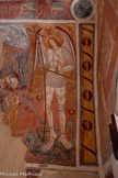 <center>Chapelle Notre-Dame de Ben-Va</center>Saint Michel Archange. Représenté en chevalier médiéval, ses longues ailes repliées dans son dos. Derrière lui est tendu un brocart doré. Il tient sa balance et surveille la pesée des âmes. En même temps il sort victorieux d'un combat apocalyptique contre Lucifer dont la figure exprime la peur et la haine avec ses yeux exorbités et ses poils hérissés. Saint Michel transperce de sa lance Satan, le mal en personne, le jaloux, le révolté, le tentateur, le chef des légions infernales. Il écrase le prince des démons. En haut de la composition, deux anges dans un fond bleu, luttent avec des démons, tandis qu’un troisième tente de préserver les âmes de nouveaux nés morts avant le baptême.