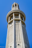 <center>La tour Perret.</center>Ici le S pour le sud. Sa hauteur de 84 m au dernier élément en béton n'est pas anodine. Auguste Perret a la possibilité d'aller haut, et souhaite donc faire 1 m de plus que la basilique du Sacré-Coeur de Montmartre qui avait été élevée en 1873 pour célébrer la victoire sur la Commune de Paris. C'est un hommage à son père Claude-Marie Perret, tailleur de pierre communard, qui avait été condamné à mort par contumace lors de la Commune.