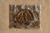 <center>Cathédrale Notre-Dame de la Nativité</center>Sur plusieurs piliers et dans la chapelle du Saint Sacrement on peut admirer de magnifiques plaques sculptées carolingiennes (an 600 à 800) à très beaux décors d'entrelacs, qui attestent de l’existence d’une très belle église carolingienne, du IXe. Ils furent découverts à la fin du 19e siècle ou au début du 20e siècle, sous le crépi des colonnes de la nef. Ce panneau représente à gauche un serpent, au milieu une sorte de grand oiseau, et à droite une sorte d’amphore comme coupée dans le sens de la longueur légèrement inclinée vers la gauche avec à l’intérieur un oiseau regardant vers le col qui est fermé.
Le grand oiseau regarde le petit dans l’amphore. Sur la droite on voit une bordure faisant imaginer que l’ensemble du motif était inscrit dans un triangle. MB pense que ce panneau aurait pu appartenir à un ambon. Dimensions : base environ 30 cm, hauteur environ 20 cm.